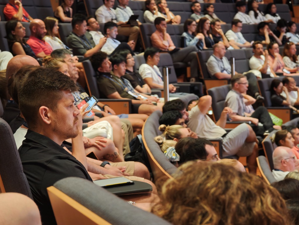 Conference audience in a lecture hall during a keynote